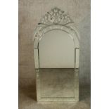 A contemporary Venetian style wall mirror with a shaped bevelled mirror plate within etched