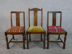 A pair of early 20th century oak dining chairs, together with a similar chair, each with drop in