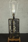 A vintage Chinese abacus table lamp on carved base, with cream fabric shade. H.55 W.18 D.12cm.