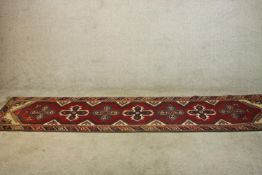 A hand made red ground Turkish Dosemealti runner. L.280 W.77cm