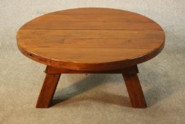 A 20th century French Brutalist pine coffee table, with a circular plank top on three splayed