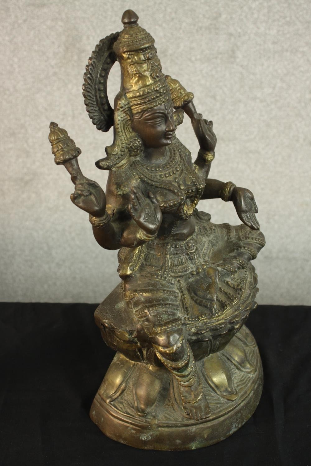 An early 20th century brass figure of the Indian deity Lakshmi on a lotus form base. (Damaged.) H.43 - Image 6 of 9