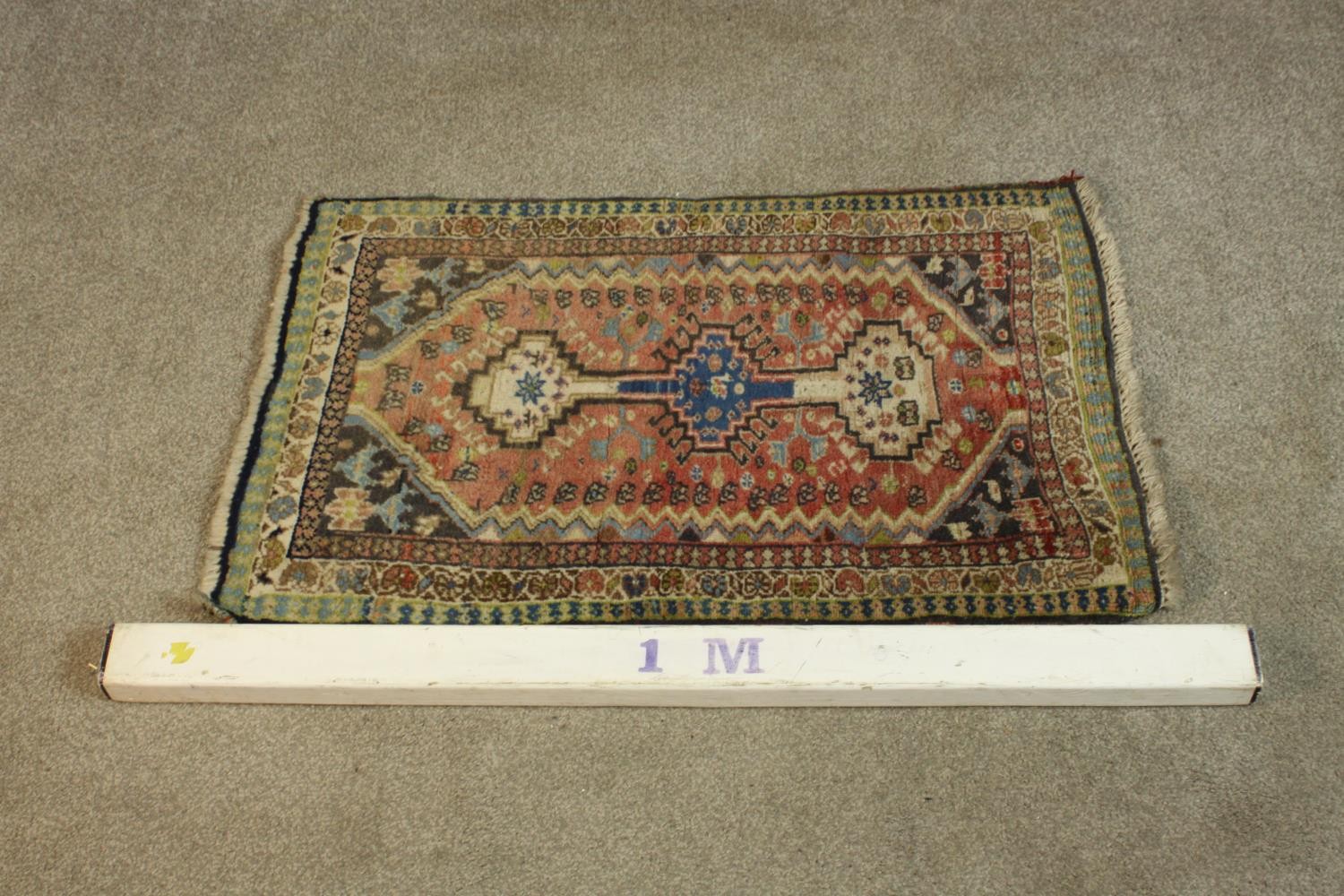 A hand woven red ground Persian Quashqai rug. L.88 W.53cm. - Image 2 of 5