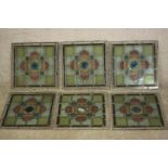 A set of six early 20th century coloured lead lined stained glass window panes with stylised