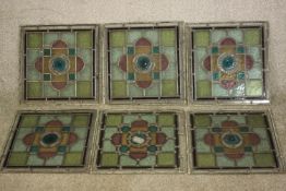 A set of six early 20th century coloured lead lined stained glass window panes with stylised