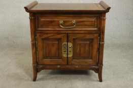 A late 20th century Chinese elm altar style cabinet, with a long drawer over two cupboard doors with