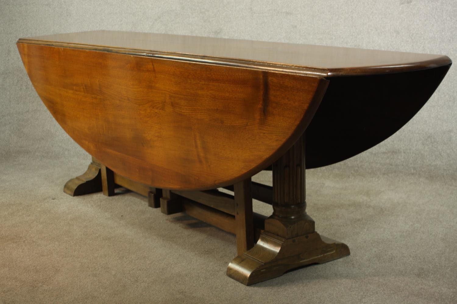 A 20th century oak drop leaf wake table, the oval top with two drop leaves raised on gate legs and - Image 4 of 12