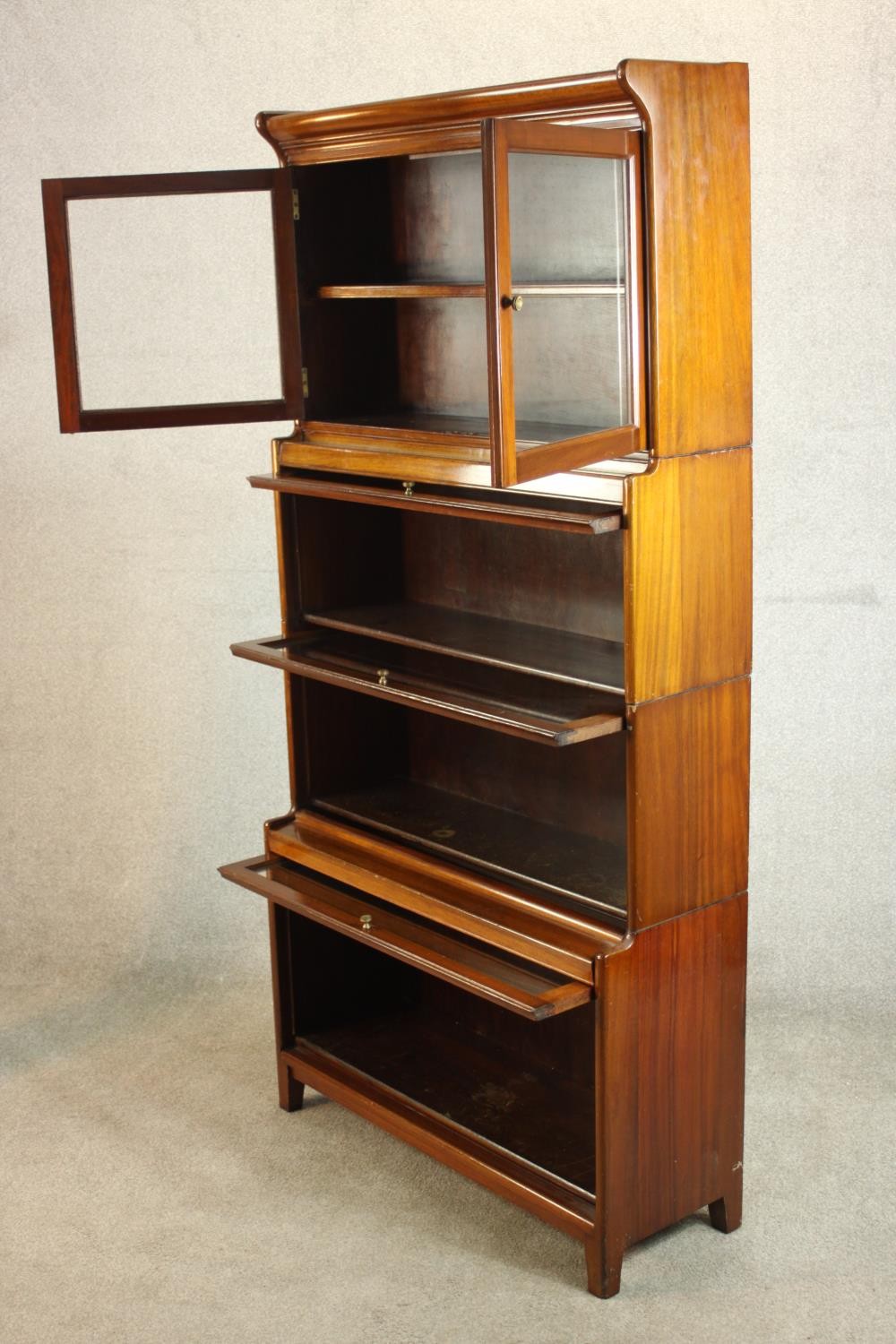 A mid 20th century mahogany Gumm stacking bookcase, with two glazed cupboard doors over three - Image 7 of 16