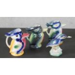 Three vintage lustre-ware kingfisher jugs along with a lustre-ware kingfisher on rock form base. H.