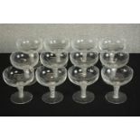 A set of twelve clear glass air twist stem champagne coupes. H.20 Dia.10cm. (largest)