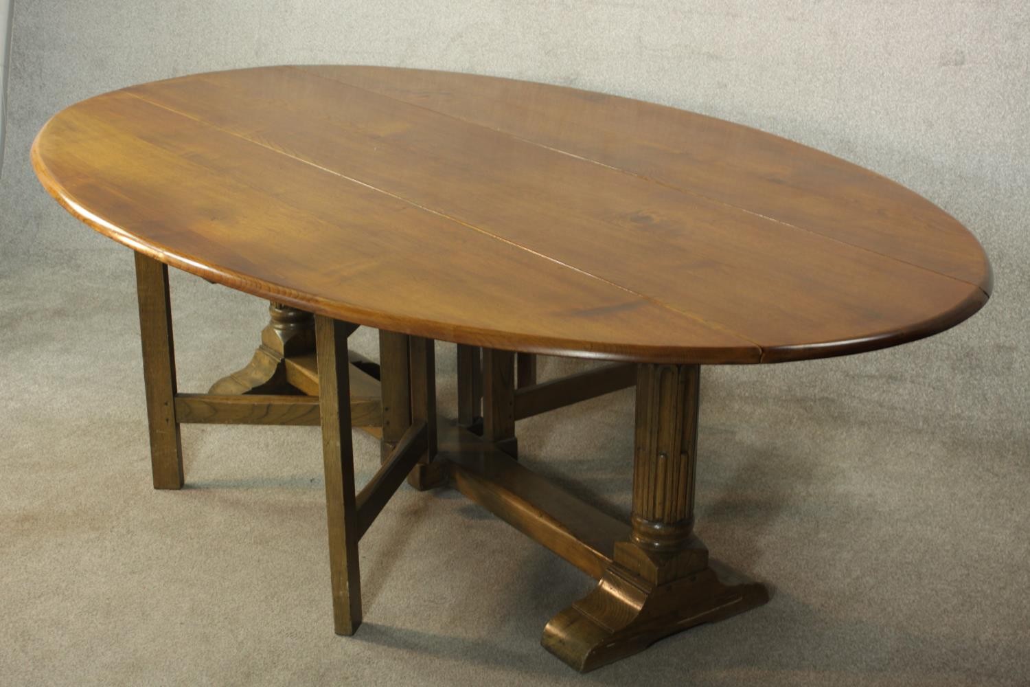 A 20th century oak drop leaf wake table, the oval top with two drop leaves raised on gate legs and - Image 6 of 12