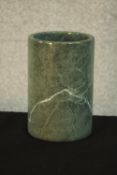 A carved and polished green and white veined marble brush pot. H.18 Dia.12cm.