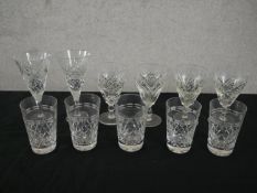 A collection of eleven crystal cut glasses with stylised foliate design, including two champagne