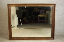 A late 19th/early 20th century oak framed rectangular wall mirror. H.109 W.133cm.