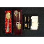 Two pairs of gilded silver plated berry spoons and a cased set of silver child's spoon and fork. (