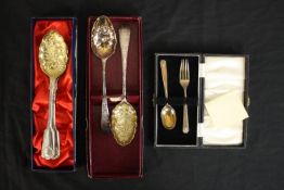 Two pairs of gilded silver plated berry spoons and a cased set of silver child's spoon and fork. (