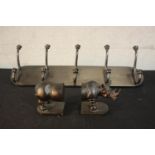 A cast iron set of six wall mounted coat hooks along with a pair of bronze effect resin Rhino