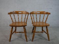 A pair of 20th century beech kitchen chairs, with spindle back, over turned legs joined by turned