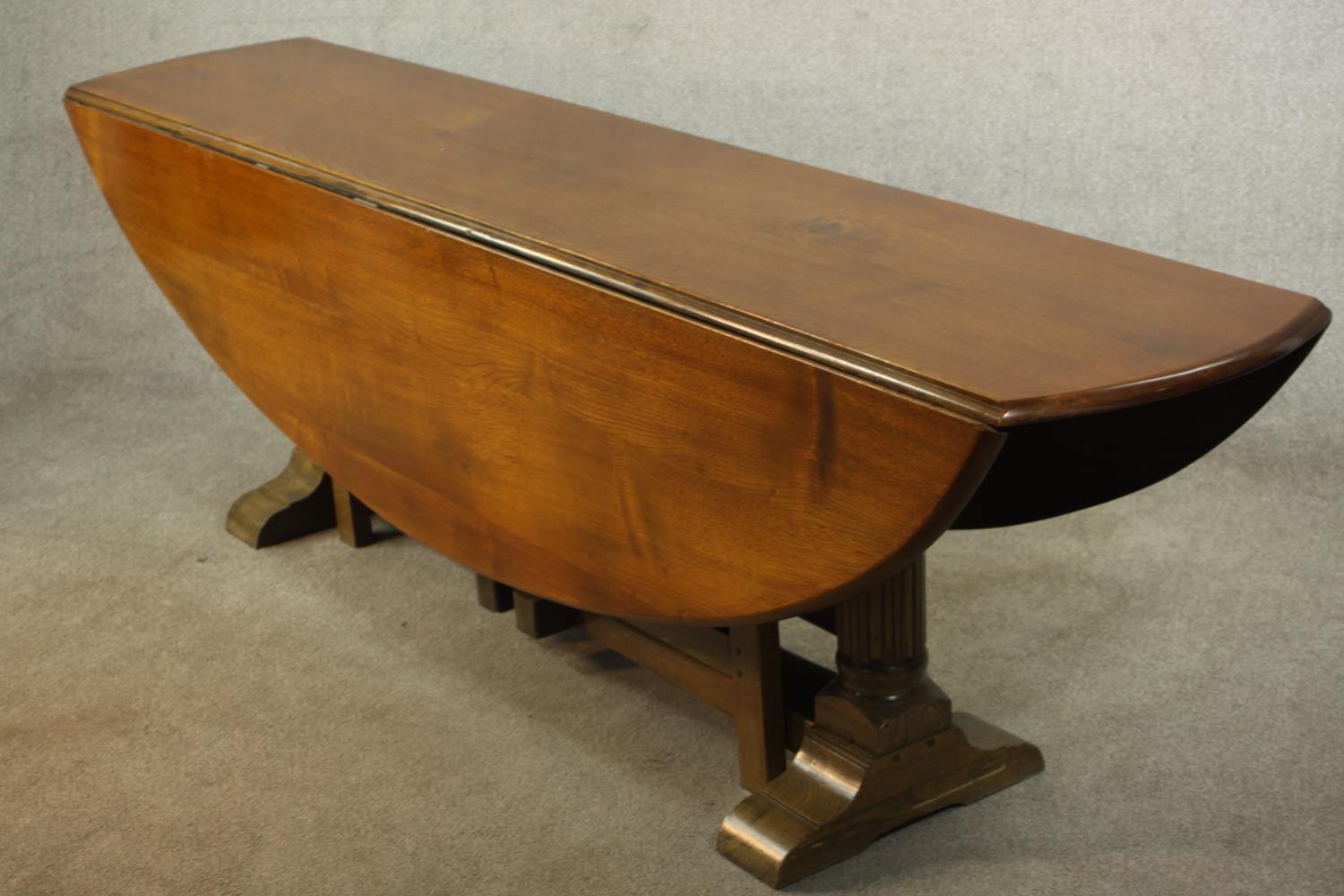 A 20th century oak drop leaf wake table, the oval top with two drop leaves raised on gate legs and - Image 3 of 12