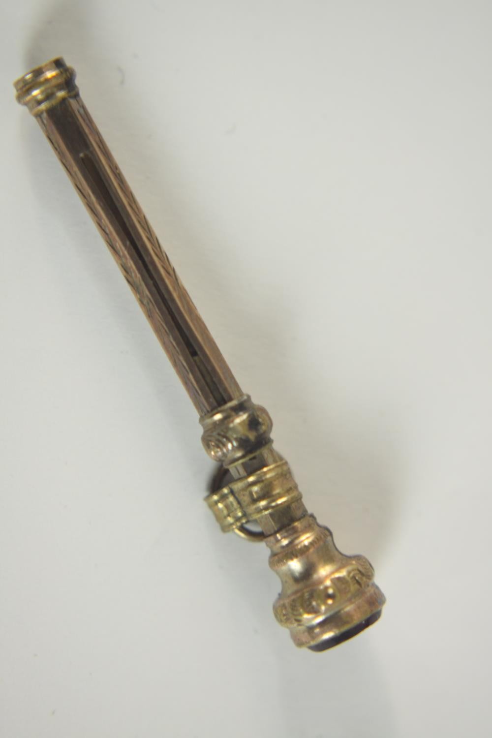 A leather cased rolled gold engraved 19th century retractable tooth pick with a garnet set to the - Image 11 of 17