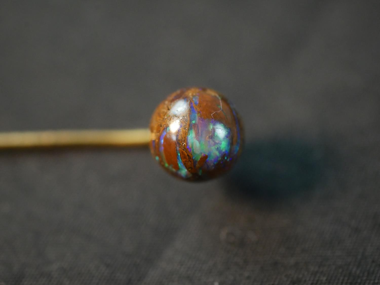 A yellow metal boulder opal stick pin, with carved and polished boulder opal ball to the end (good - Image 3 of 8