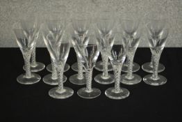 A set of fifteen clear glass air twist stem sherry glasses. H.15 Dia.6cm. (largest)