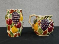 A Siltone pottery hand painted relief fruit design jug and matching flower vase, stamped to base.