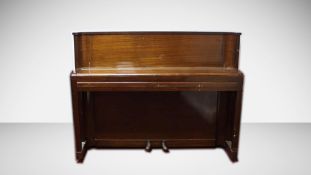 An Art Deco mahogany cased Ritz Model small upright piano, with a cast iron frame. H.101 W.132 D.