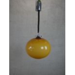 A 1970’s Rolly Brevettato pendant light with amber glass globe shade. H.57cm