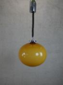 A 1970’s Rolly Brevettato pendant light with amber glass globe shade. H.57cm