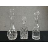 Three cut glass and crystal decanters, each of different design. H.35cm (largest)