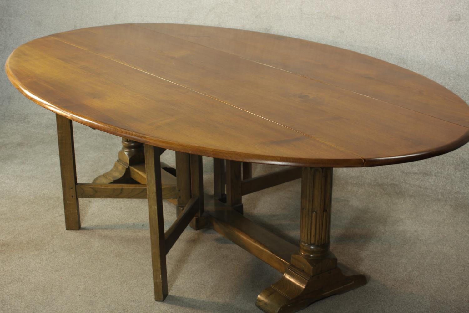 A 20th century oak drop leaf wake table, the oval top with two drop leaves raised on gate legs and - Image 7 of 12