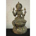 An early 20th century brass figure of the Indian deity Lakshmi on a lotus form base. (Damaged.) H.43