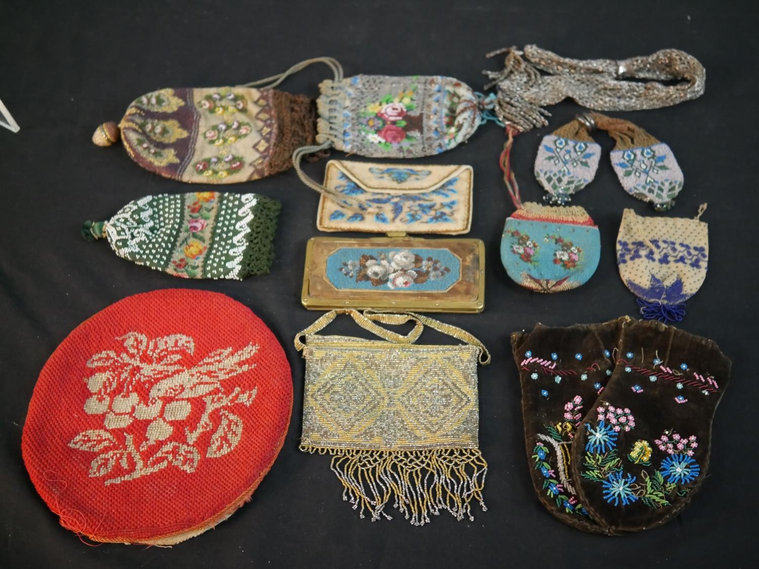 A collection of twelve antique hand beaded and embroidered bags each with a different design and
