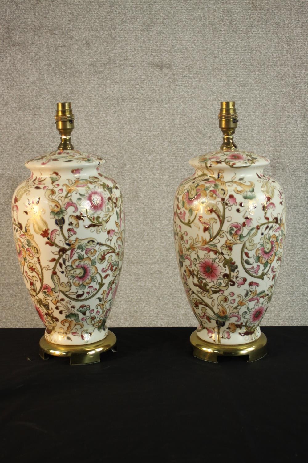 A pair of gilded foliate and floral design table lamps in the form of vases. H.44 Dia.22cm (each)