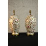A pair of gilded foliate and floral design table lamps in the form of vases. H.44 Dia.22cm (each)