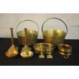 A collection of early 20th century brassware, including two brass preserve pans, two pairs of candle