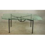 A Danny Lane glass top table with abstract design on wrought iron base, signed. H.72 W.170 D.83cm