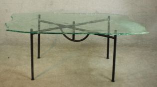 A Danny Lane glass top table with abstract design on wrought iron base, signed. H.72 W.170 D.83cm