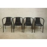 A set of four contemporary powder coated metal framed garden chairs, with woven wicker upholstery.