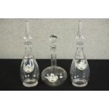 A pair of cut glass decanters with air twist design stoppers along with another decanter, each