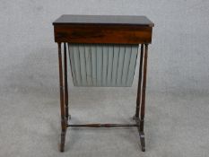 A 19th century rosewood work table, with a rectangular rising lid and fitted interior, over a