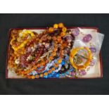 A collection of costume jewellery including twelve vintage necklaces, a faux amber bracelet and