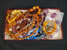 A collection of costume jewellery including twelve vintage necklaces, a faux amber bracelet and