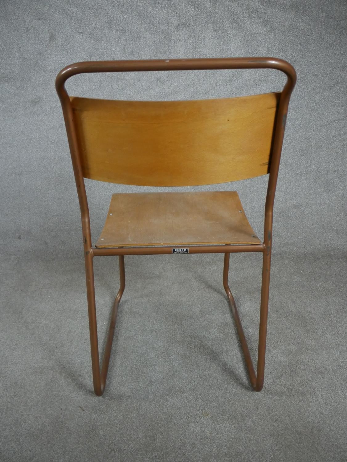 A set of four 1950s Redro plywood stacking school chairs, on brown painted tubular frames. H.84 W.44 - Image 6 of 6