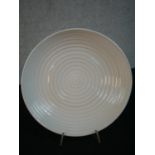 A white glazed bowl by Simon Moore, decorated with concentric circles. Diam.35cm