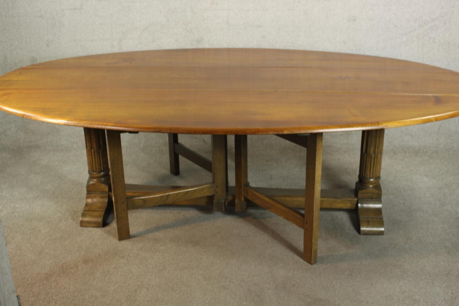 A 20th century oak drop leaf wake table, the oval top with two drop leaves raised on gate legs and - Image 5 of 12
