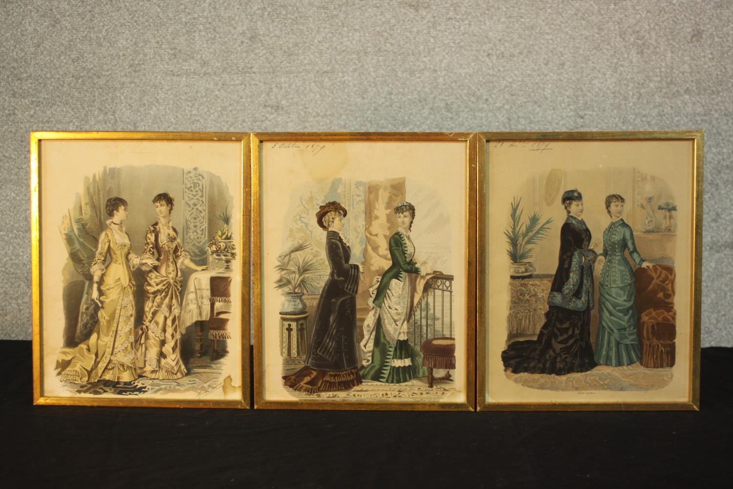 Three framed and glazed 19th century hand coloured engravings of ladies in various dress designs,