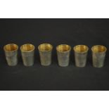 A set of six German silver shot glasses by Adolf Kander with gilded interior. German hallmarks to