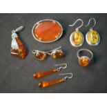 A collection of Amber jewellery and a carnelian and silver oval brooch. Amber jewellery includes,